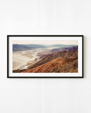 Ochre slopes and violet mountain ridges overlook pale Death Valley flats from Dante’s View.