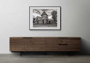 Monochrome photograph of St Andrew’s Church, adjoining buildings and a leafy tree in Yukon.