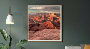 Orange light reaches the upper canyon walls while deep shadows mark the ravines below.