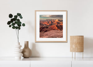A river follows the curved canyon floor amid rugged red rock at Dead Horse Point.