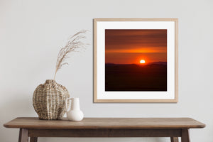 Small silhouettes along the rural horizon stand against the warm glow of a Quebec sunrise.