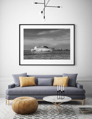 Weathered vessel anchored off Key West with a distant shoreline and dark water.