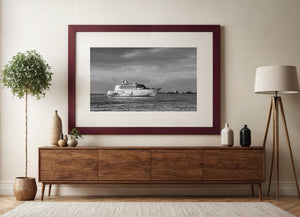 Streaks of cloud above a derelict Key West yacht, monochrome maritime scene.