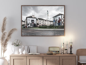 Quiet residential street framed by large Bogside murals in Northern Ireland.