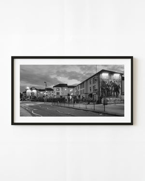 Derry Bogside murals and residential facades at twilight, black and white street photograph.