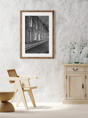 Panelled doorway and repeated windows in a Derry terrace, black and white architecture.