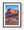 Pale desert shrubs beneath sunlit red rock cliffs and a clear blue sky.