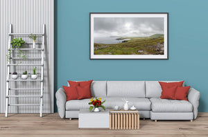 Dingle Peninsula coast with field boundaries and grey sea under soft cloud light.