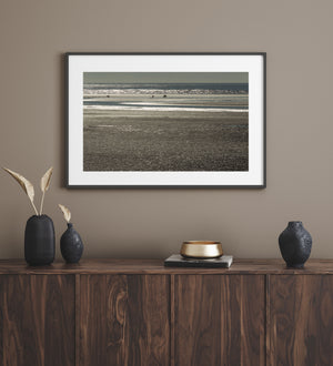 Distant wildlife across sunlit water on the Alaska coast