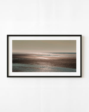 Distant brown bears across reflective Alaska tidal flats at sunset
