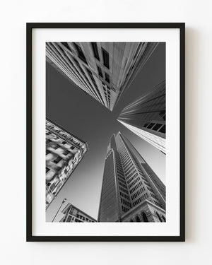 Downtown Dallas skyscrapers converging overhead in black and white