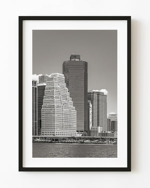Downtown Manhattan skyscrapers seen across the water in black and white