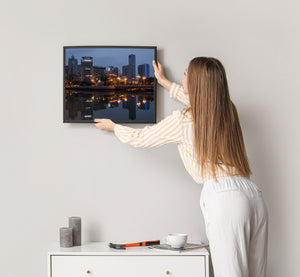 Evening city lights mirrored on river surface