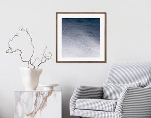 Ocean droplets and white foam against a deep blue sea