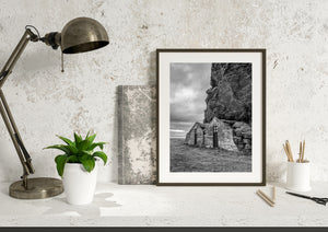 Drangshlid rural architecture and dramatic rock face in monochrome