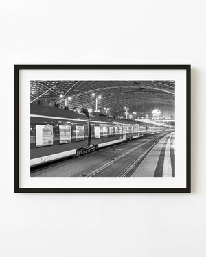 Dresden train station with passenger train and platforms in black and white