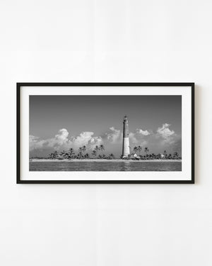 Dry Tortugas lighthouse and palms beneath clouds in black and white