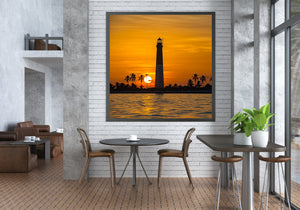 Lighthouse and tropical island shore in golden sunset light