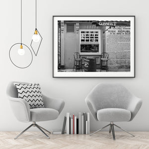 Warmly lit pub window on a Dublin city street