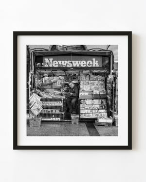 Dublin newspaper seller at a crowded newsstand in black and white