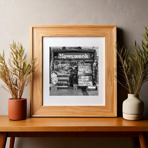 Square monochrome photograph of everyday life at a Dublin newspaper stall