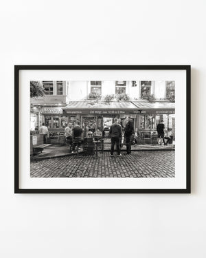 People outside a Dublin pub in an evening black and white street scene
