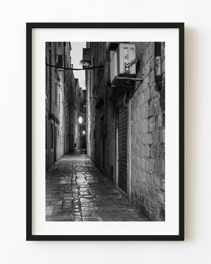 Narrow stone lane in Dubrovnik, Croatia, photographed in black and white