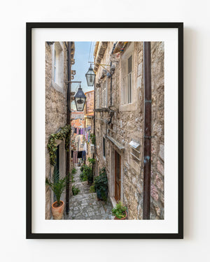 Stone stairway descending through a narrow Dubrovnik old town lane