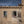 Dubrovnik stone facade with a woman at an open window and a cat nearby
