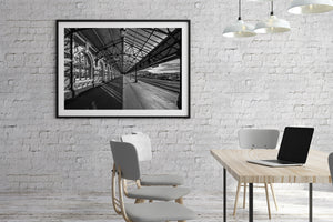 Dunedin train station platform with stone arches and overhead steel framing