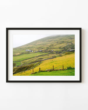 Green hillside divided by stone walls at Dunmore Head, Ireland