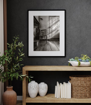 Sunlight and shadow across a rustic wooden farmhouse interior