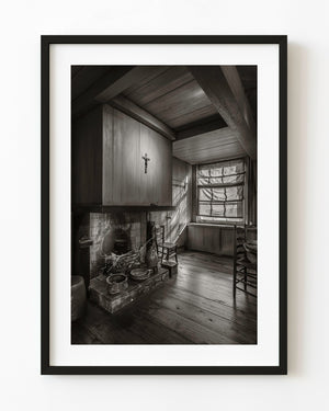 Sepia Dutch kitchen interior with a hearth, wooden beams and window light