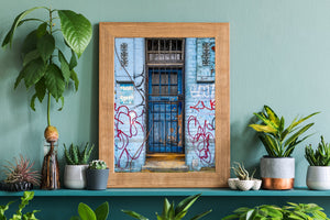 Old blue London doorway with graffiti and a worn stone threshold