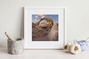 Warm brown rock formations surrounding an opening to the sky