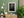Monochrome Eiffel Tower rising above a shadowed Paris path after rain