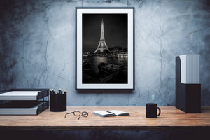 Nighttime Paris skyline with the Eiffel Tower beyond dark boat decks