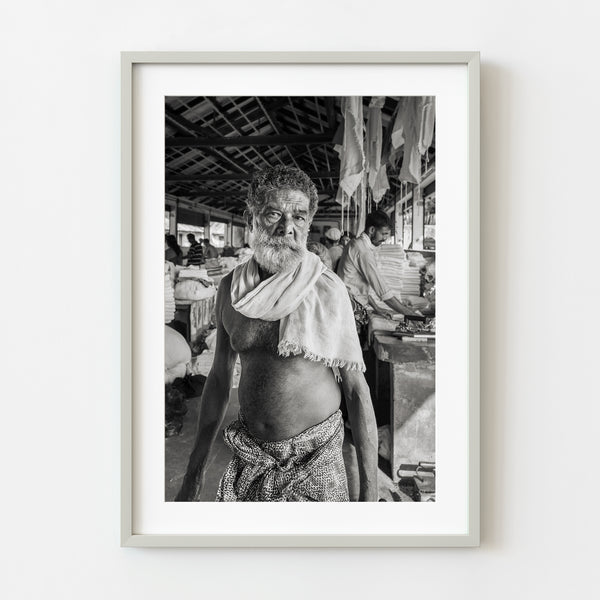 Black and white portrait of elderly man in laundry in Kochi, India