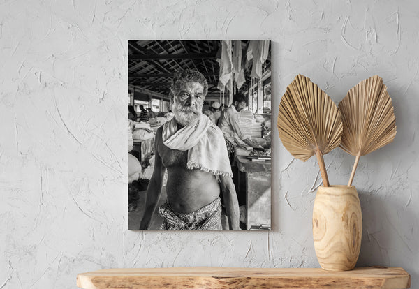 Man in traditional dress working in laundry – black and white