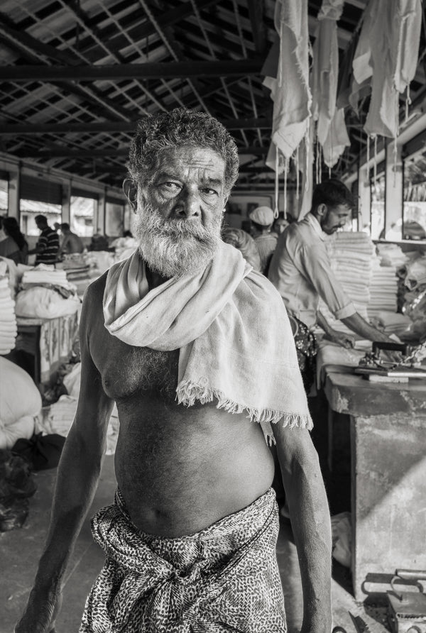 Elderly man working in laundry, Kochi – black and white