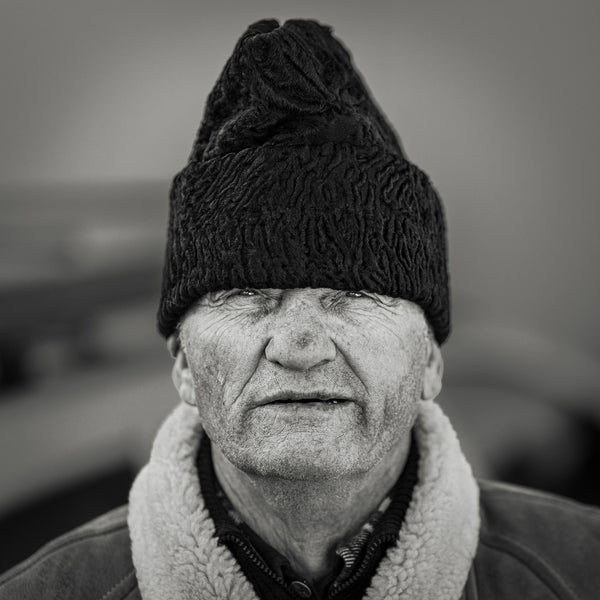 Elderly Romanian man with black hat – black and white portrait