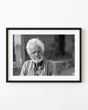 Black and white portrait of an elderly Indian man with glasses, white hair and a pale beard