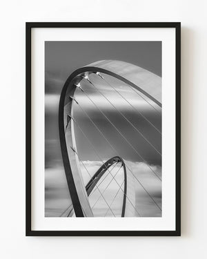 Sweeping arches and suspension cables of Elizabeth Quay Bridge in Perth, photographed in black and white.