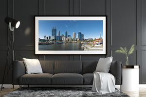Perth cityscape showing modern glass buildings and brick architecture beside the water.