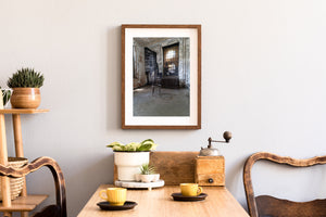 Archival images on the walls and window of an abandoned hospital room on Ellis Island.