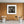 An old radiator stands below a partially covered window in a decaying interior.