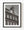 Rows of windows and a tall chimney on an English brick house in black and white.