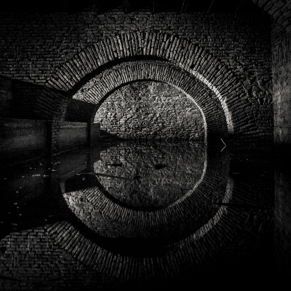 Black and white stone arch reflection