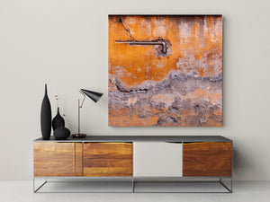 Orange and grey wall textures surround a dark exposed pipe.