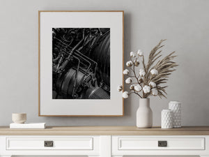 Black and white F1 engine detail with layered tubes and textured metal surfaces.